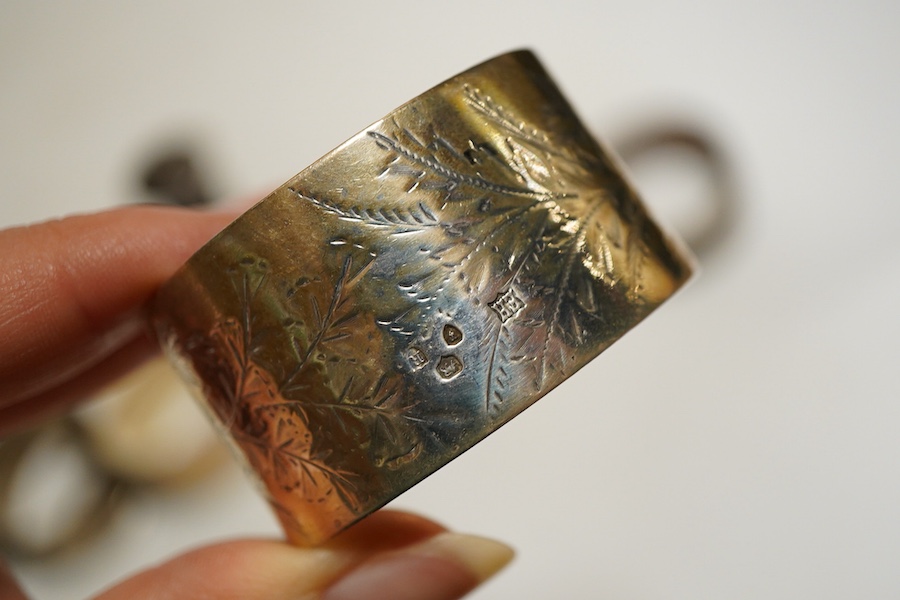 Assorted silver napkin rings, to include a George V engine turned oval pair, Birmingham, 1933, I S Greenberg & Co, initialled, four others and a pepper pot, weight approx. 6.34ozt